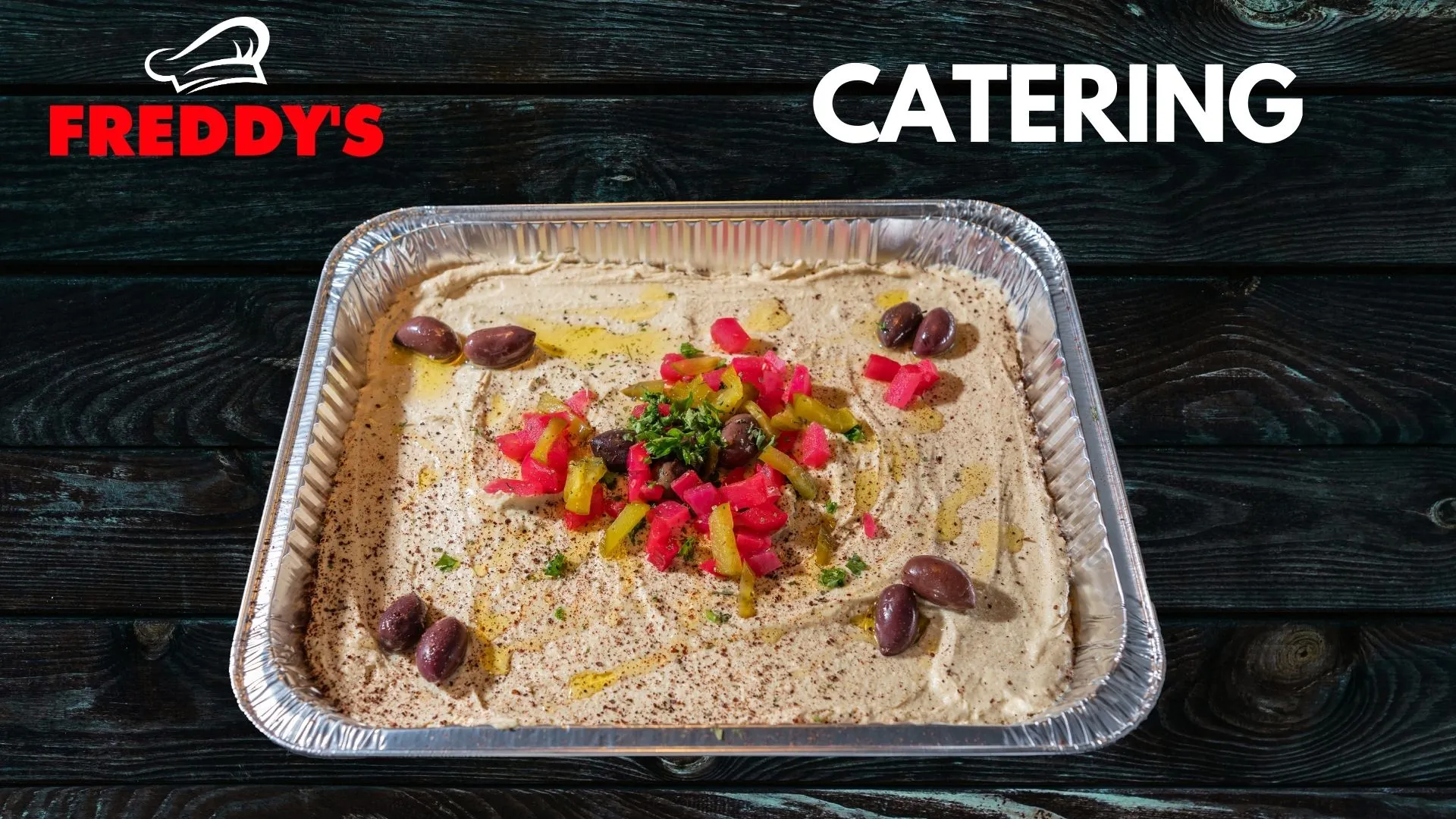 Freddy's catering hummus tray with olives and peppers